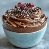 High-protein chocolate cottage cheese mousse cups topped with fresh berries and dark chocolate shavings.  