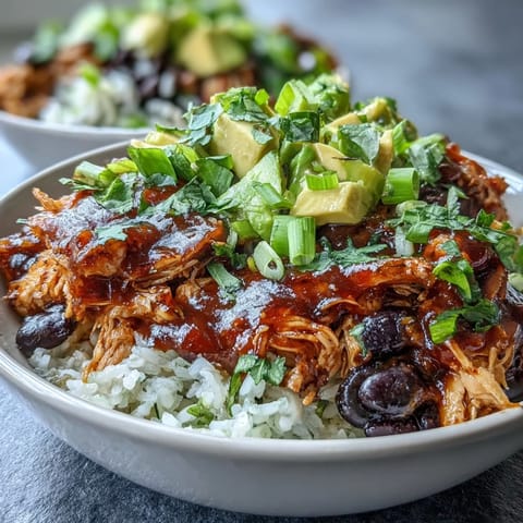 Vibrant salsa chicken bowls with shredded chicken in spicy tomato salsa, served over rice with black beans, corn, and fresh avocado.  
