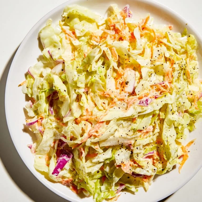 Close-up of a colorful bowl of coleslaw, ready to be served, and refreshing on a warm day.