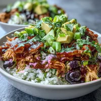 Vibrant salsa chicken bowls with shredded chicken in spicy tomato salsa, served over rice with black beans, corn, and fresh avocado.  